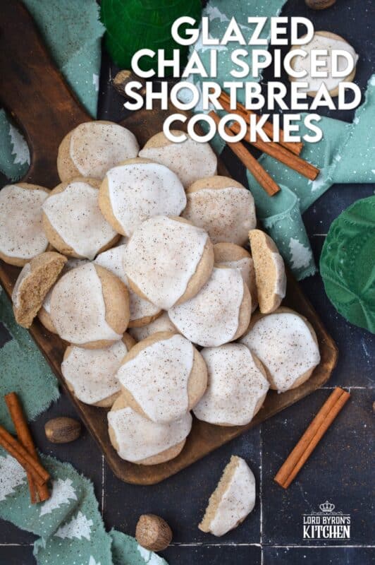 Glazed Chai Spiced Shortbread Cookies are buttery, light, and airy. The cookies are infused with familiar chai spices like cinnamon, nutmeg, ginger, cloves, and cardamom. Once cooled, the cookies are flooded with a delightfully smooth and sweet glaze; these cookies are bound to be a holiday favourite! #chai #cookies #cardamom #glazed #christmas