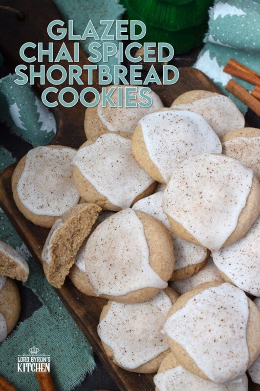 Glazed Chai Spiced Shortbread Cookies are buttery, light, and airy. The cookies are infused with familiar chai spices like cinnamon, nutmeg, ginger, cloves, and cardamom. Once cooled, the cookies are flooded with a delightfully smooth and sweet glaze; these cookies are bound to be a holiday favourite! #chai #cookies #cardamom #glazed #christmas