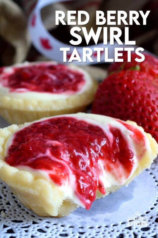 An easy to assemble treat perfect for any Canada Day celebration. Red Berry Swirl Tartlets are flaky, buttery, creamy, and sweet. Buy store-bought frozen tart shells to make this recipe fast and easier. These are stuffed with a cream cheese filling and a red berry compote! #tarts #tart #berry #tartlets