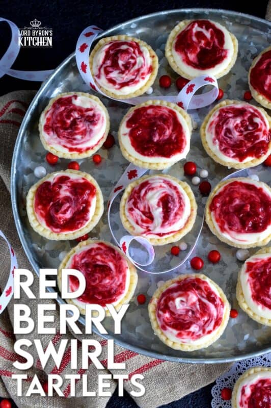 An easy to assemble treat perfect for any Canada Day celebration. Red Berry Swirl Tartlets are flaky, buttery, creamy, and sweet. Buy store-bought frozen tart shells to make this recipe fast and easier. These are stuffed with a cream cheese filling and a red berry compote! #tarts #tart #berry #tartlets