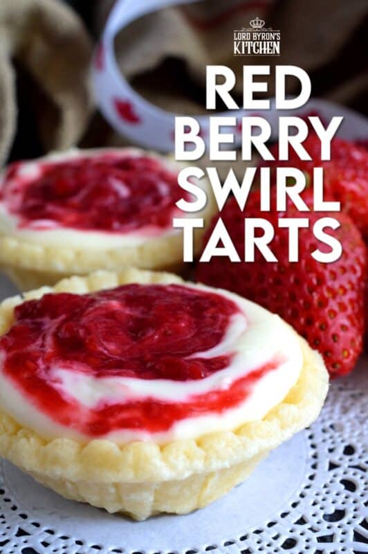 An easy to assemble treat perfect for any Canada Day celebration. Red Berry Swirl Tartlets are flaky, buttery, creamy, and sweet. Buy store-bought frozen tart shells to make this recipe fast and easier. These are stuffed with a cream cheese filling and a red berry compote! #tarts #tart #berry #tartlets