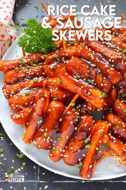 A popular Korean snack, tteok kkochi, are pan-fried rice cakes that become slightly crispy on the outside, yet retain that crave-worthy soft and chewy interior. Served on a wooden stick, these Rice Cake and Sausage Skewers are sweet and spicy and one of the best things I've eaten in a very long time! You simply have to try these! #ricecakes #sausage #skewers #korean #tteok