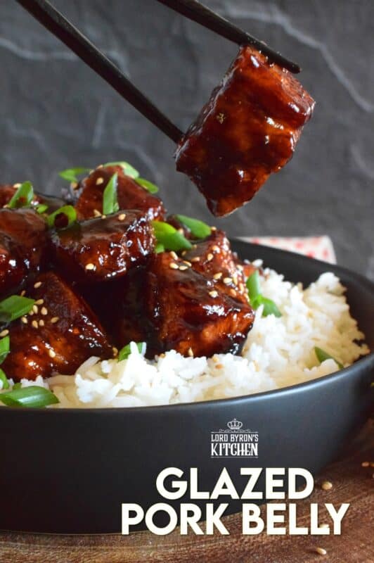 This sweet and sticky Glazed Pork Belly is cooked in two stages. First, the meat is boiled with seasonings and then fried before being cooked in a brown sugar, soy sauce, and rice wine reduction. Served with steamed rice, this is a meal that would please the toughest critic! #porkbelly #pork #belly