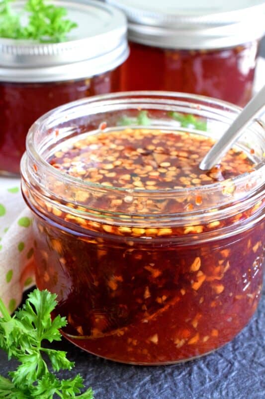 You'll find a thousand ways to use this Thai Sweet Chili Dipping Sauce! It's a little spicy, a little sweet, and a little acidic, which makes a great dip for spring rolls! Spoon some over fried rice or use it as a marinade for chicken or pork. These jars make great gifts too! #dippingsauce #chilisauce #sweet #spicy #thai #dip