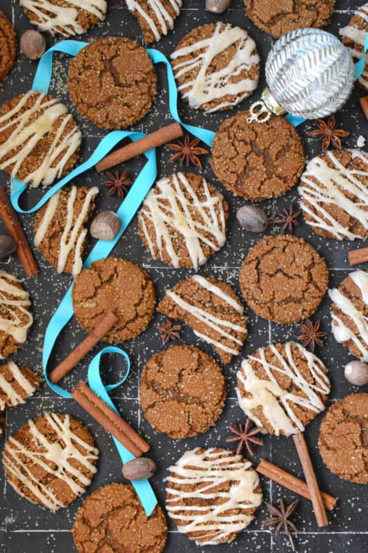 Latte Gingerbread Cookies are prepared with classic Christmas ingredients like ginger, cloves, cinnamon, instant espresso powder, and molasses. Once baked, the cookies are drizzled with a brown butter frosting. The taste of these cookies instantly floods the senses with memories of Christmases past! #gingerbread #latte #cookies #espresso #christmas