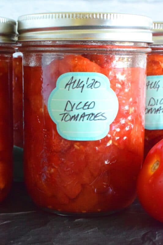Many recipes include Canned Diced Tomatoes. Why not make your own with those local and fresh end of summer tomatoes? They're very budget-friendly and taste so much better than what you can buy in a store. Stock your pantry and have that fresh tomato flavour all winter long! #canned #diced #tomatoes #canning #preserves