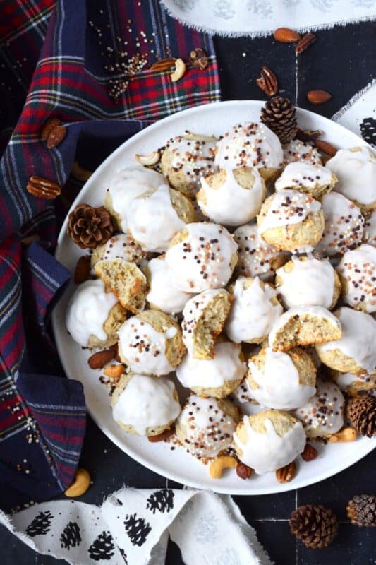 Alert the Mouse King because these Glazed Nutcracker Cookies are prepared with a copious amount of chopped nuts! Using salted nuts balances out the sweetness of the delicate, soft cookie and provides ample crunch and texture. Make extra and share them with your friends - just don't snack on them at the ballet! #nutcracker #christmas #cookies #glazed #nuts #nutty