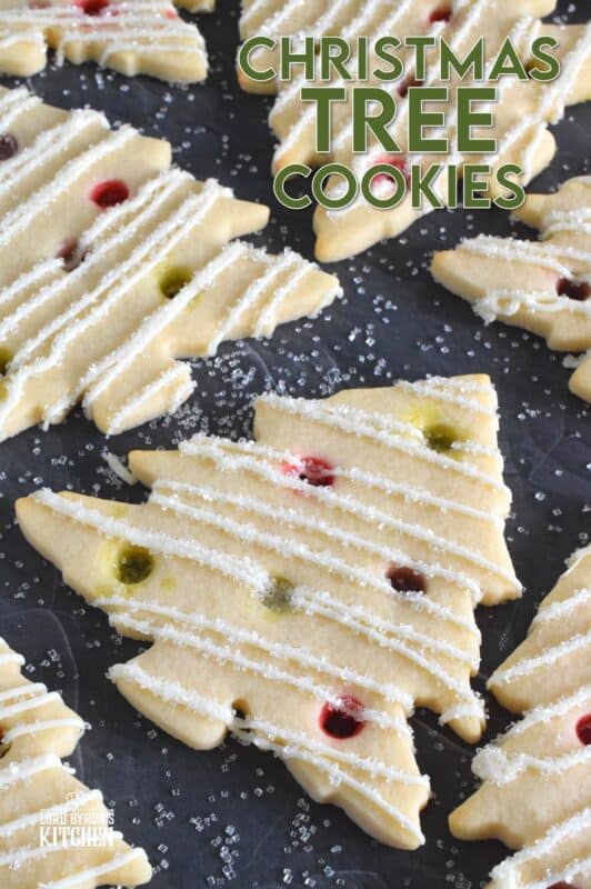 Dig out your tree-shaped cookie cutter and whip up a batch of these Christmas Tree Cookies! The ornaments are easy to make with crushed candy and they're baked right into the cookie dough. It's like adding decoration and flavour at the same time! #christmas #cookies #tree