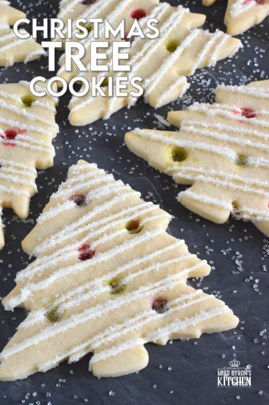 Dig out your tree-shaped cookie cutter and whip up a batch of these Christmas Tree Cookies! The ornaments are easy to make with crushed candy and they're baked right into the cookie dough. It's like adding decoration and flavour at the same time! #christmas #cookies #tree