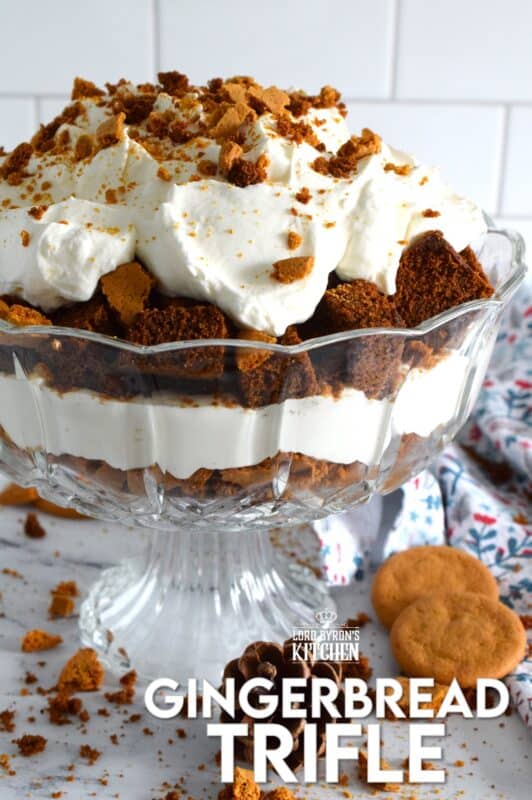 Homemade gingerbread cake makes up the bulk of this Gingerbread Trifle. Layered with fluffy whipped cream, crushed gingersnap cookies, and candied sugary ginger, this dessert is the perfect warm and cozy finish to a family holiday meal! #gingerbread #trifle #ginger #nobake