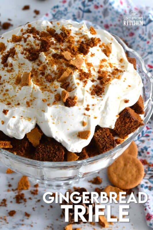 Homemade gingerbread cake makes up the bulk of this Gingerbread Trifle. Layered with fluffy whipped cream, crushed gingersnap cookies, and candied sugary ginger, this dessert is the perfect warm and cozy finish to a family holiday meal! #gingerbread #trifle #ginger #nobake