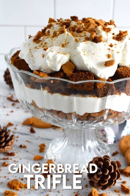 Homemade gingerbread cake makes up the bulk of this Gingerbread Trifle. Layered with fluffy whipped cream, crushed gingersnap cookies, and candied sugary ginger, this dessert is the perfect warm and cozy finish to a family holiday meal! #gingerbread #trifle #ginger #nobake