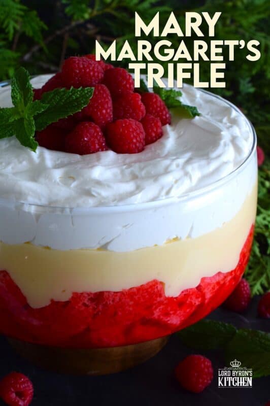 Mary Margaret's Trifle is a simple, rustic, uncomplicated dessert comprised of three layers. Starting with a pound cake layer where the cake is soaked in raspberry jello, followed by a thick layer of custard and topped with freshly prepared whipped cream. #trifle #vintage #retro #raspberry #jello #custard