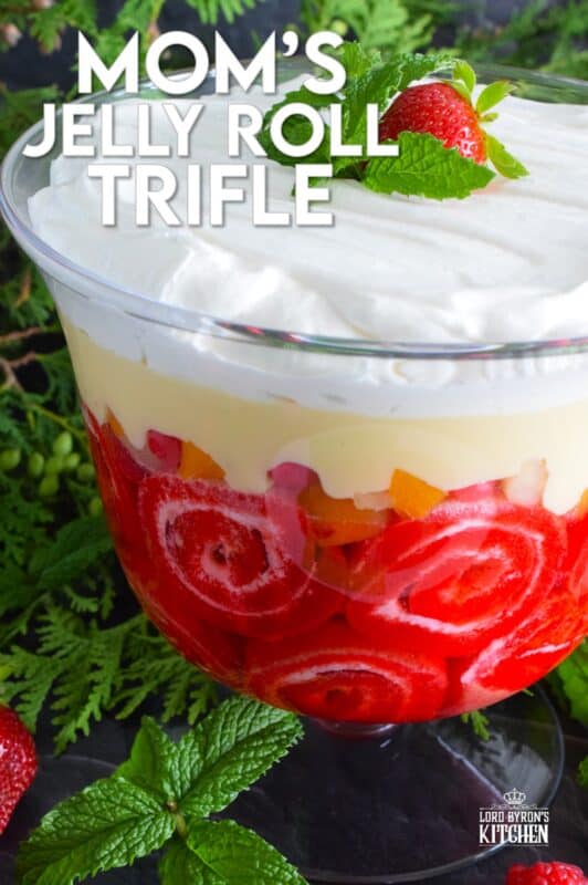 Mom's Jelly Roll Trifle starts with a store-bought raspberry jelly roll that is sliced and layered with raspberry jello, custard, fruit cocktail, and dream whip. This uncomplicated dessert, with its humble beginnings, is how I remember my mom's deliciously satisfying Sunday trifle. #trifle #cocktail #jellyroll #dessert