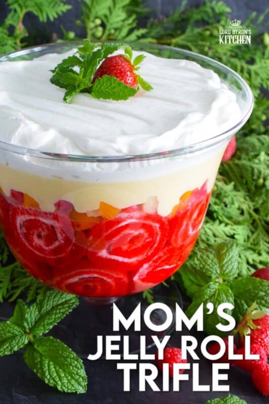 Mom's Jelly Roll Trifle starts with a store-bought raspberry jelly roll that is sliced and layered with raspberry jello, custard, fruit cocktail, and dream whip. This uncomplicated dessert, with its humble beginnings, is how I remember my mom's deliciously satisfying Sunday trifle. #trifle #cocktail #jellyroll #dessert