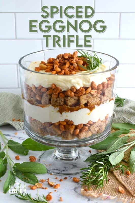 Starting with a homemade eggnog-infused, holiday rum cake, this Spiced Eggnog Trifle is layered with an eggnog cream cheese rum filling and candied mixed nuts.  Drizzled with a thick, sweet caramel sauce, this trifle is sure to be a hit!  Optionally, this recipe easily converts to a rum-free version too! #trifle #spiced #eggnog #cake #caramel #nuts