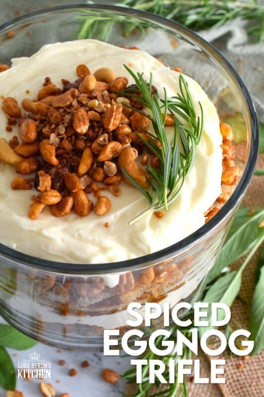 Starting with a homemade eggnog-infused, holiday rum cake, this Spiced Eggnog Trifle is layered with an eggnog cream cheese rum filling and candied mixed nuts.  Drizzled with a thick, sweet caramel sauce, this trifle is sure to be a hit!  Optionally, this recipe easily converts to a rum-free version too! #trifle #spiced #eggnog #cake #caramel #nuts
