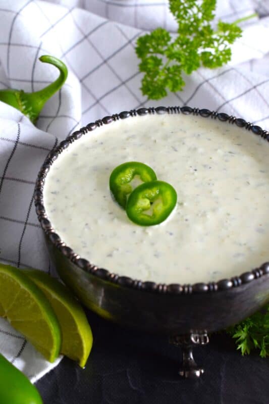 This spicy mayonnaise has just a few basic ingredients and takes about five minutes to prepare. Blender Jalapeno Mayo uses store-bought mayonnaise and combines it with fresh jalapenos, ground black pepper, parsley, garlic, onion, and lime juice. It's a spread, it's a dip, and it's a sauce! #sauce #mayo #jalapeno #spicy