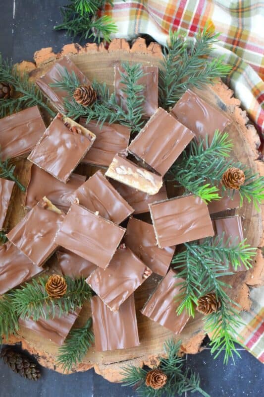 Loaded with toasted pecans, these Pecan Toffee Bars have a shortbread crumb base and a caramel, pecan center. Topped with melted milk chocolate, these bars are just heavenly! This is a holiday confection that will be difficult to share and part with. Maybe it's a good idea to make a double batch of these after all! #toffee #pecan #squares #bars