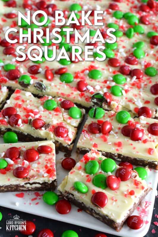 No Bake Christmas Squares have a rich, chocolatey base prepared with crushed cookies, cocoa, and brown sugar. They are topped with melted white chocolate, crushed candy canes, and holiday M&Ms. Only 25 minutes from start to finish! #mms #nobake #christmas #peppermint #cookies #bars #squares
