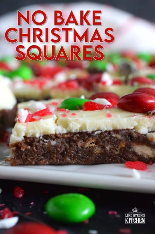 No Bake Christmas Squares have a rich, chocolatey base prepared with crushed cookies, cocoa, and brown sugar. They are topped with melted white chocolate, crushed candy canes, and holiday M&Ms. Only 25 minutes from start to finish! #mms #nobake #christmas #peppermint #cookies #bars #squares
