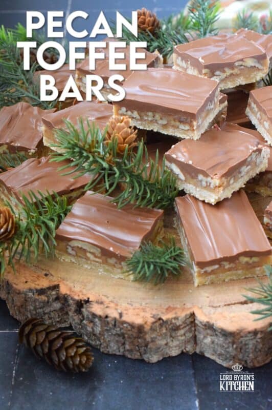 Loaded with toasted pecans, these Pecan Toffee Bars have a shortbread crumb base and a caramel, pecan center. Topped with melted milk chocolate, these bars are just heavenly! This is a holiday confection that will be difficult to share and part with. Maybe it's a good idea to make a double batch of these after all! #toffee #pecan #squares #bars