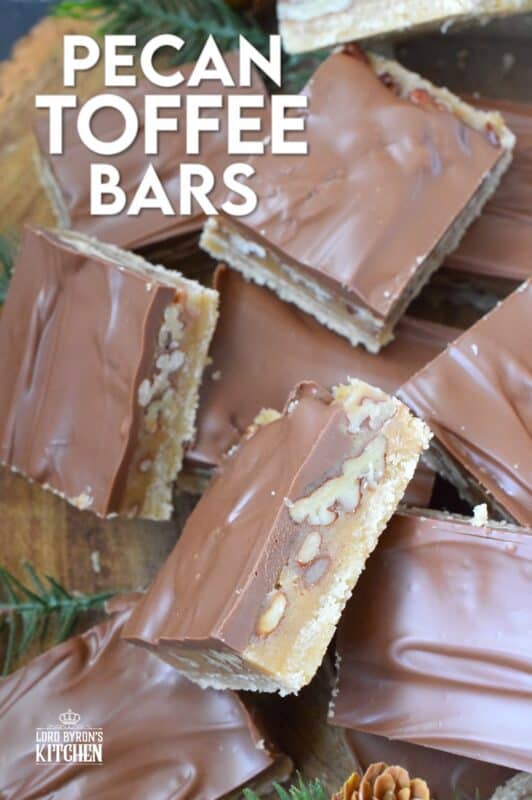 Loaded with toasted pecans, these Pecan Toffee Bars have a shortbread crumb base and a caramel, pecan center. Topped with melted milk chocolate, these bars are just heavenly! This is a holiday confection that will be difficult to share and part with. Maybe it's a good idea to make a double batch of these after all! #toffee #pecan #squares #bars