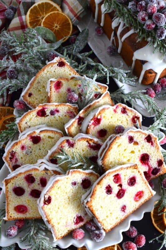 Moist and delicious, orangey and refreshing, packed with fresh cranberries and orange zest, and drizzled with a sweet glaze, Orange Cranberry Loaf is a perfect dessert or a lovely addition to your afternoon tea. This is delicious anytime, but the combination of oranges and cranberries is a must at Christmastime! #cranberry #orange #loaf #bread #glazed