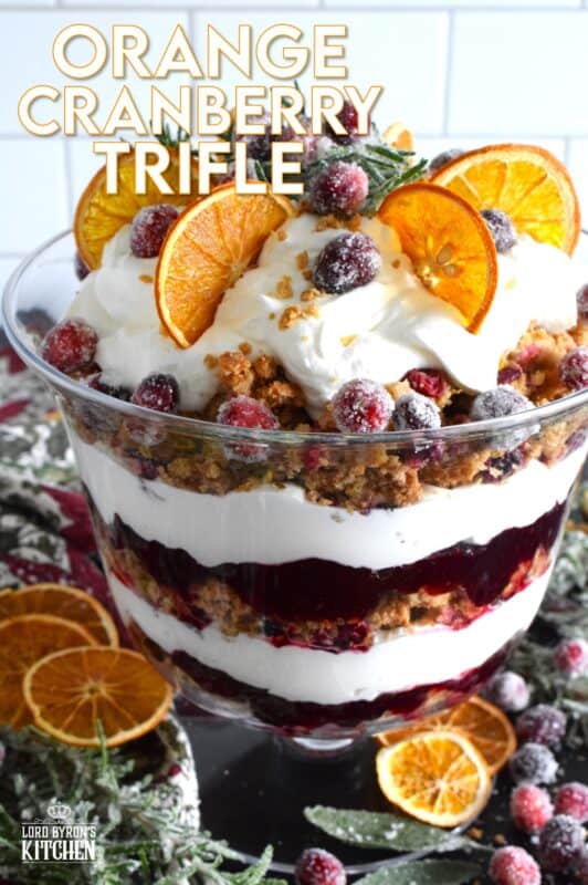 Freshly homemade cranberry squares are crumbled and layered with a delicious orange and rosemary-infused whipped cream. Topped with sugared cranberries and rosemary, this Orange Cranberry Trifle is a mouthwatering, showstopping holiday dessert! #trifle #cranberry #orange