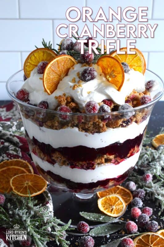 Freshly homemade cranberry squares are crumbled and layered with a delicious orange and rosemary-infused whipped cream. Topped with sugared cranberries and rosemary, this Orange Cranberry Trifle is a mouthwatering, showstopping holiday dessert! #trifle #cranberry #orange