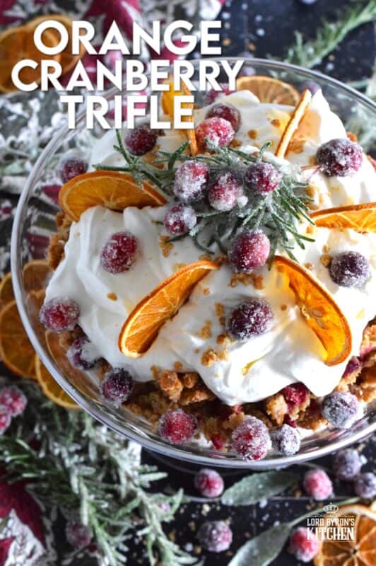 Freshly homemade cranberry squares are crumbled and layered with a delicious orange and rosemary-infused whipped cream. Topped with sugared cranberries and rosemary, this Orange Cranberry Trifle is a mouthwatering, showstopping holiday dessert! #trifle #cranberry #orange