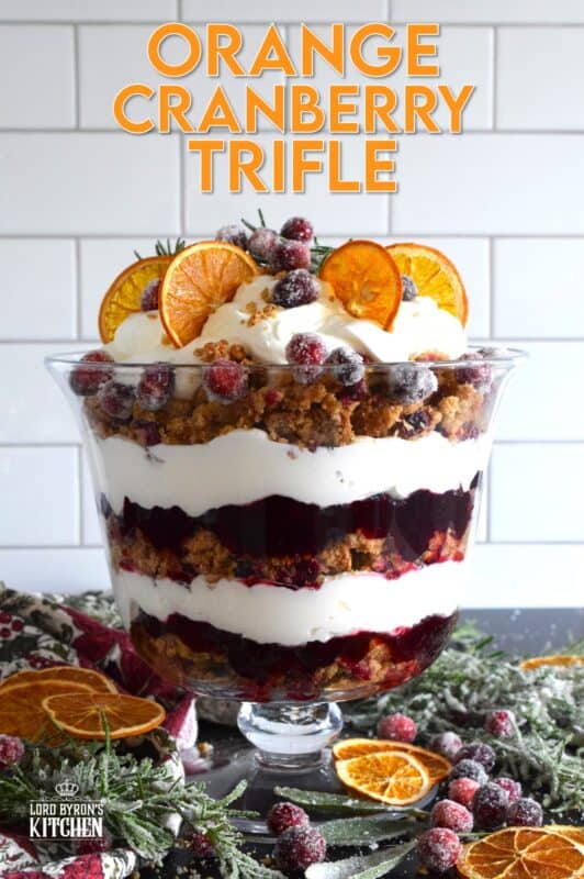 Freshly homemade cranberry squares are crumbled and layered with a delicious orange and rosemary-infused whipped cream. Topped with sugared cranberries and rosemary, this Orange Cranberry Trifle is a mouthwatering, showstopping holiday dessert! #trifle #cranberry #orange