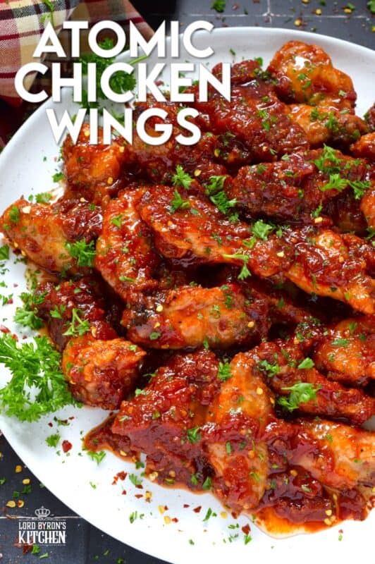 If wings dripping with a spicy and savoury sauce are what you're looking for, you've found them! Atomic Chicken Wings are baked until crispy and then tossed in a homemade sweet and spicy sauce made with crushed tomatoes, hot sauce, brown sugar, and lots of aromatic seasonings. You've never eaten wings this good! #chicken #wings #saucy #atomic #spicy #sweet #copycat #wingstop