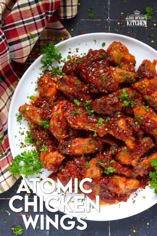 If wings dripping with a spicy and savoury sauce are what you're looking for, you've found them! Atomic Chicken Wings are baked until crispy and then tossed in a homemade sweet and spicy sauce made with crushed tomatoes, hot sauce, brown sugar, and lots of aromatic seasonings. You've never eaten wings this good! #chicken #wings #saucy #atomic #spicy #sweet #copycat #wingstop