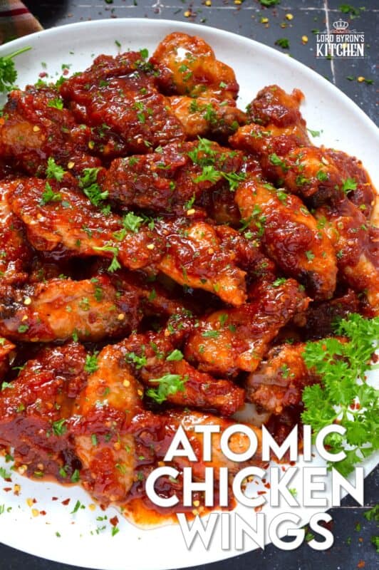 If wings dripping with a spicy and savoury sauce are what you're looking for, you've found them! Atomic Chicken Wings are baked until crispy and then tossed in a homemade sweet and spicy sauce made with crushed tomatoes, hot sauce, brown sugar, and lots of aromatic seasonings. You've never eaten wings this good! #chicken #wings #saucy #atomic #spicy #sweet #copycat #wingstop
