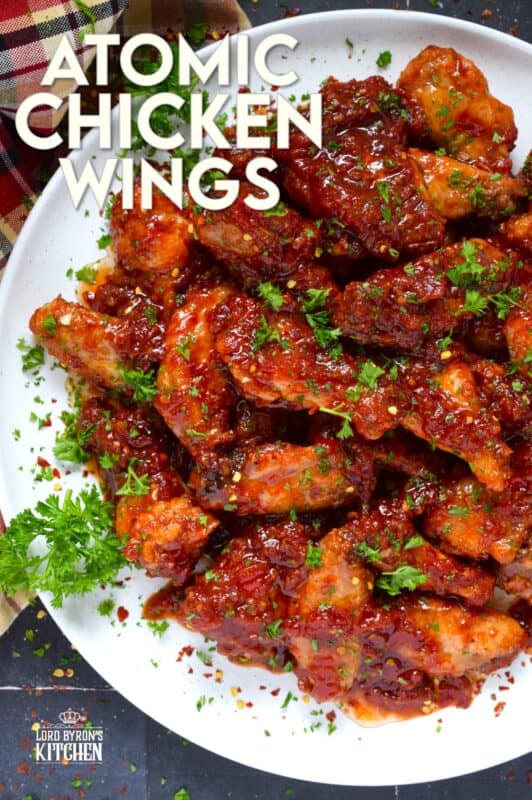 If wings dripping with a spicy and savoury sauce are what you're looking for, you've found them! Atomic Chicken Wings are baked until crispy and then tossed in a homemade sweet and spicy sauce made with crushed tomatoes, hot sauce, brown sugar, and lots of aromatic seasonings. You've never eaten wings this good! #chicken #wings #saucy #atomic #spicy #sweet #copycat #wingstop