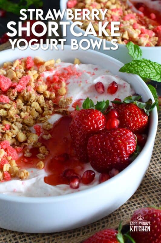 Strawberry shortcake crumbs are stirred into Greek yogurt and then topped with fresh strawberries, more shortcake crumbs, a drizzle of homemade quick and easy strawberry syrup, and a little granola for added crunch and flavour. Strawberry Shortcake Yogurt Bowls make a great summer Sunday brunch menu option! #strawberry #shortcake #crumbs #yogurt #bowls #brunch #summer