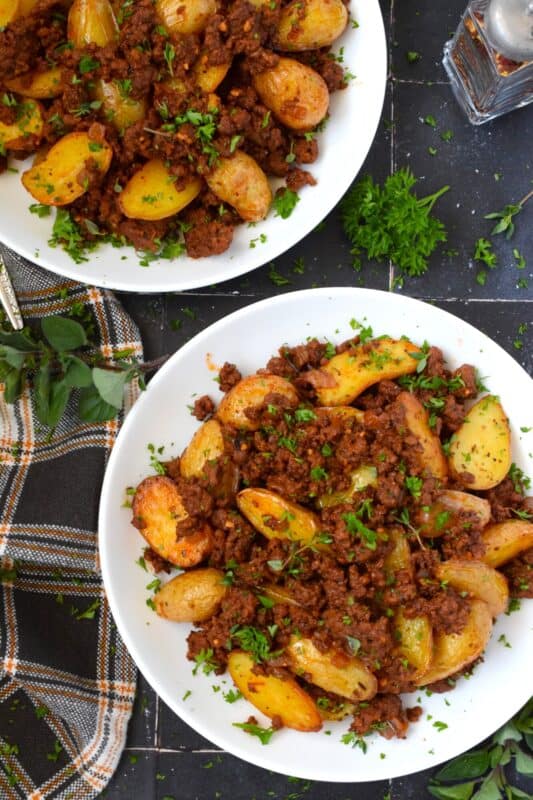 Perfectly seasoned and cooked ground beef is coupled with roasted baby potatoes. This simple meat and potatoes dinner can be on the table in about 30 minutes or less! Prepared with tomato paste and aromatics like garlic and onion, Roasted Potatoes and Ground Beef Dinner is an easy and delicious weeknight supper! #roastedpotatoes #groundbeef #dinner #meatandpotatoes