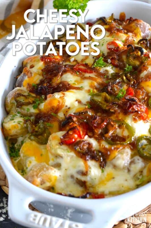 Cheesy Jalapeno Potatoes just might be my new obsession! Baby potatoes are tossed with seasonings, sour cream, and cheese and then transferred to a baking dish. Topped with caramelized onion and jalapenos, the potatoes are baked until browned and bubbly. These are simply amazing! #potatoes #cheesy #jalapenos #sourcream #bubbly #side
