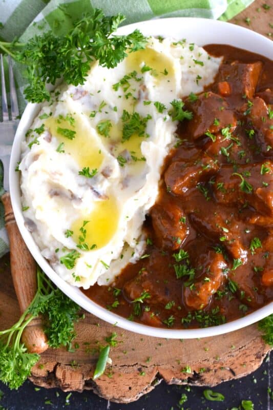Loaded with chuck beef roast and slow-cooked with carrots, onion, and celery, this Beef Guinness Gravy is almost a complete meal on its own! Looking for a delicious, hearty meal that's easy to prepare? Serve this savoury, beer-infused gravy with your favourite mashed buttery potatoes! #guinness #gravy #beef #beer