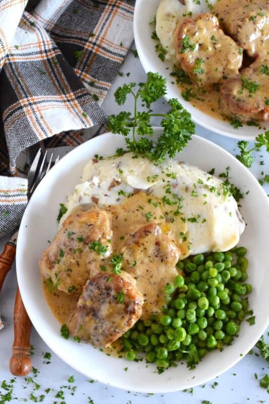A weeknight family favourite to be sure, these Pork Tenderloin Medallions in Honey Mustard Cream Sauce are quick and easy to prepare, but more importantly, they are delicious! Seared and simmered in a savoury, herby, warming sauce, you can be sure the pork is browned on the outside yet moist and tender on the inside! #pork #tenderloin #honeymustard #sauce #creamy #family #dinner
