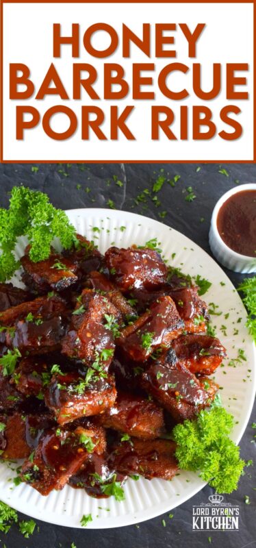 Moist and tender, these pork ribs are enclosed and baked to lock in flavour and texture before they are basted in a deliciously savoury and sweet honey barbecue sauce and broiled until slightly charred. Serve these ribs with lots of napkins, because the sauce is sticky and generous! #ribs #porkribs #honey #barbecue #bbq #baked