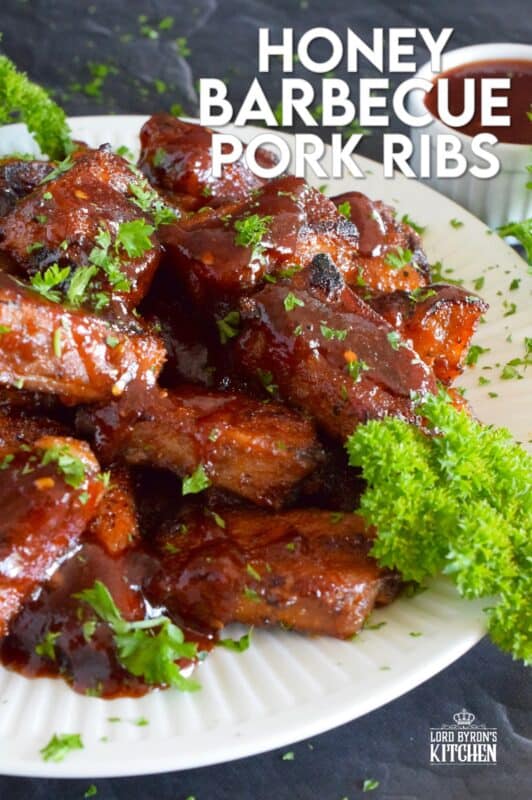 Moist and tender, these pork ribs are enclosed and baked to lock in flavour and texture before they are basted in a deliciously savoury and sweet honey barbecue sauce and broiled until slightly charred. Serve these ribs with lots of napkins, because the sauce is sticky and generous! #ribs #porkribs #honey #barbecue #bbq #baked