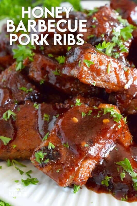 Moist and tender, these pork ribs are enclosed and baked to lock in flavour and texture before they are basted in a deliciously savoury and sweet honey barbecue sauce and broiled until slightly charred. Serve these ribs with lots of napkins, because the sauce is sticky and generous! #ribs #porkribs #honey #barbecue #bbq #baked
