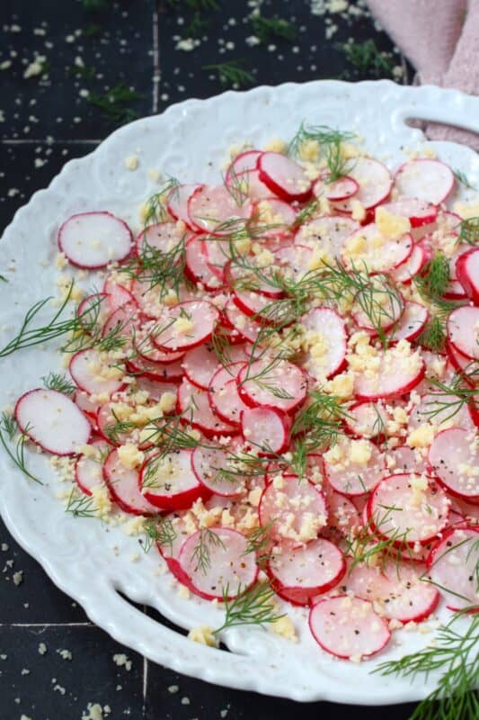 Combine the peppery crunch of freshly sliced radishes with the acidity of a lemon, the nutty saltiness of parmesan, and the bright, freshness of dill to make a light and refreshing side, salad, or snack! #radishes #radish #salad #peppery #parmesan #fresh #snack