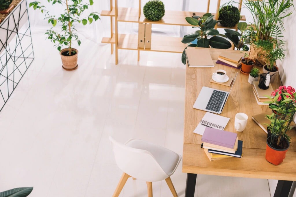 Home office with laptop on desk for the article How To Start a Business With No Money